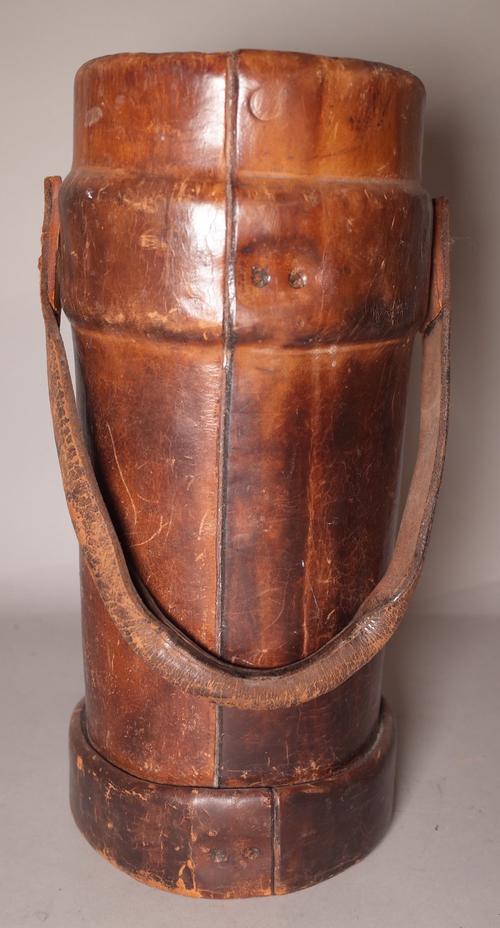 An early 20th century brown leather shot carrier, 41cm high.