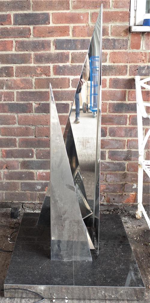 A 20th century chrome angular lamp, on a marble square plinth base, 61cm wide x 109cm high.