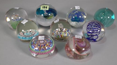 A group of nine 20th century glass paperweights, two signed to base, the largest 9cm high, (9).