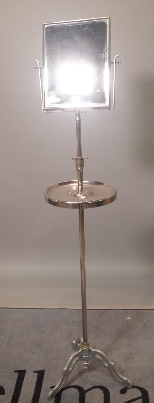 A mid-20th century chrome plated pedestal shaving stand, with swing frame mirror over shelf, on tripod base, 145cm high.