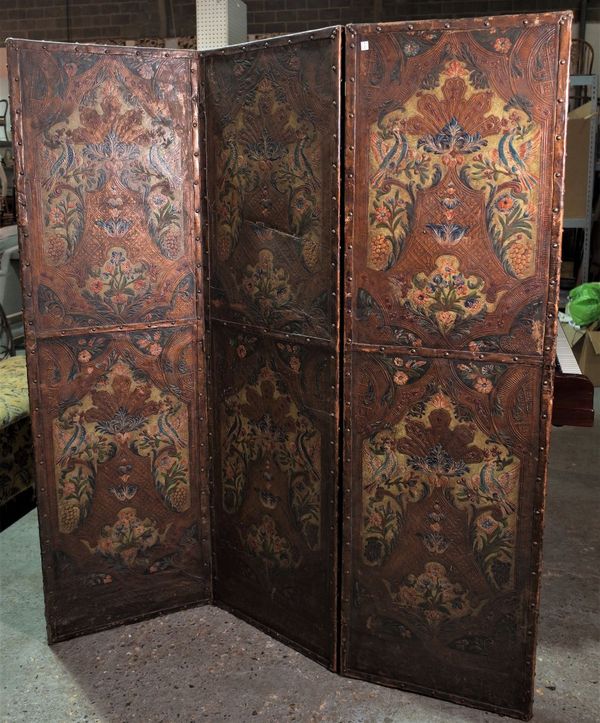 An early 20th century embossed leather three fold screen, 184cm high.