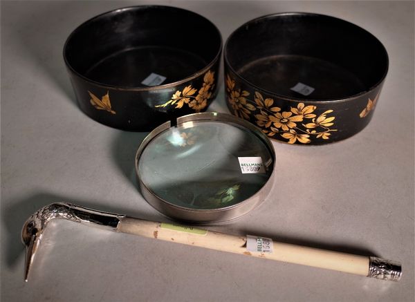 A silver mounted magnifying glass with swan head handle, (a.f.) and a pair of black lacquer and gilt decorated bottle coasters, (3).