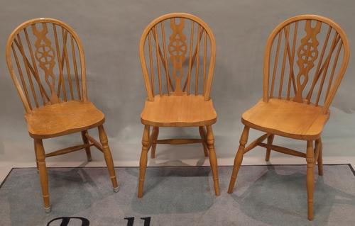 A set of eight 20th century beech wheel back dining chairs on turned supports, 38cm wide x 91cm high, (8).