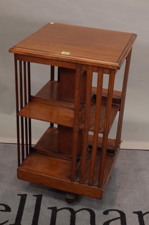 An Edwardian mahogany revolving open bookcase, 47cm wide x 83cm high, and an Edwardian mahogany two drawer sewing table, 37cm wide x 75cm high, (2).
