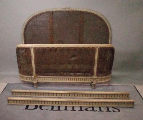 An early 20th century green painted French cane work double bed on fluted tapering supports, 140cm wide x 119cm high.