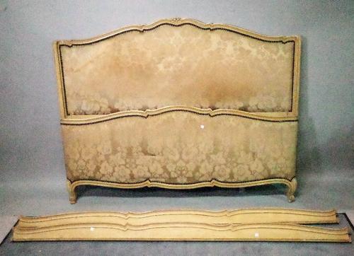 An early 20th century French green painted double bed with foliate upholstery, 152cm wide x 119cm high.