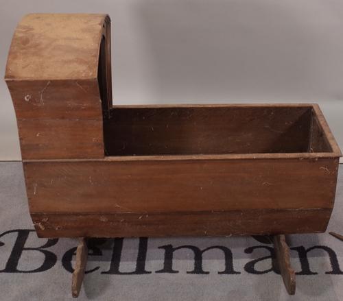 A 19th century oak rocking cradle with arched canopy, 92cm wide x 78cm high, and another similar later cradle, 86cm wide x 66cm high, (2).
