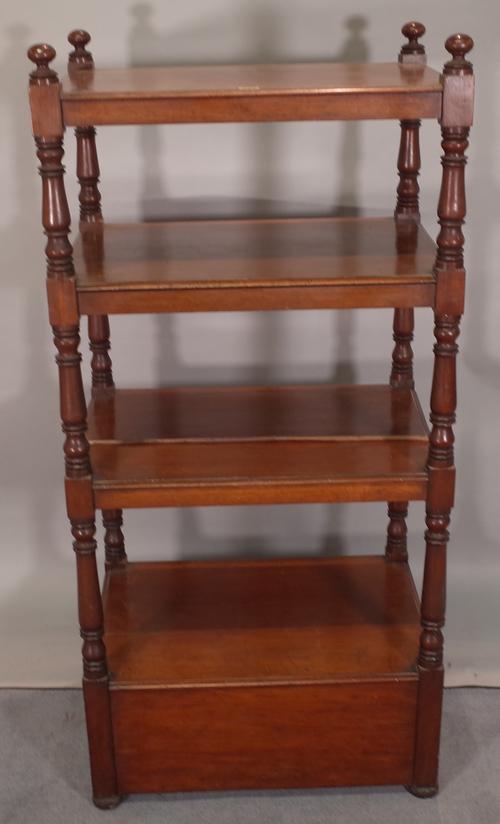 A late Victorian mahogany four tier what-not with cupboard base on turned supports, 66cm wide x 140cm high.