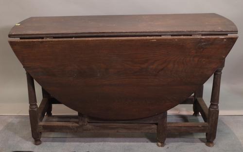 An 18th century and later oak gateleg dining table on turned supports, 130cm wide x 73cm high.