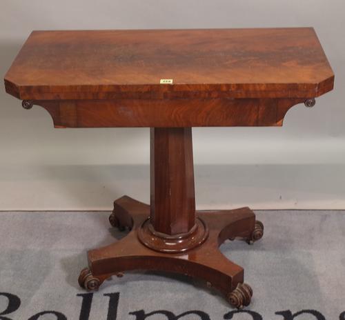 A Victorian walnut foldover tea table on octagonal turned column quaterfoil base, 87cm wide x 74cm high.