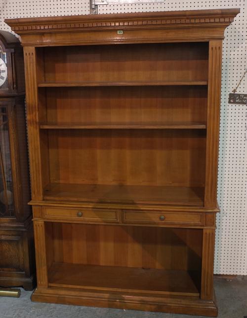 A 20th century stained beech open bookcase with two short central drawers on plinth base, 130cm wide x 198cm high.