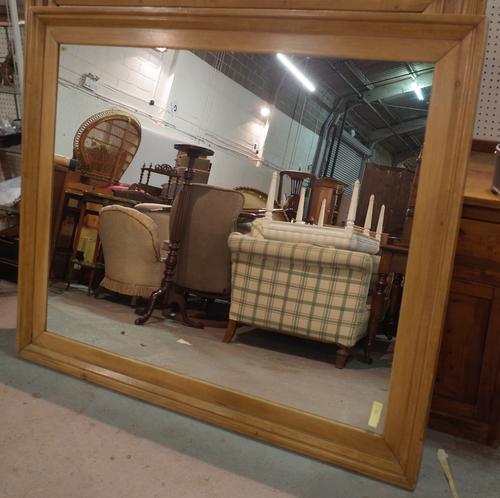 An early 20th century pine rectangular wall mirror, 167cm wide x 141cm high.