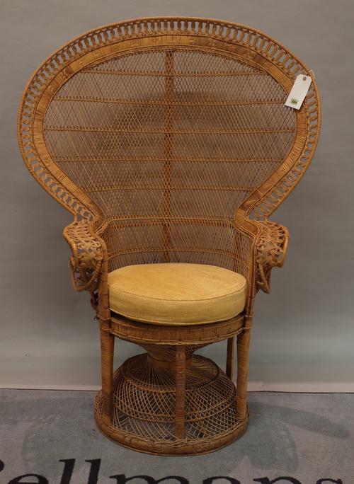 An early 20th century wicker peacock armchair, 73cm high x 144cm high.