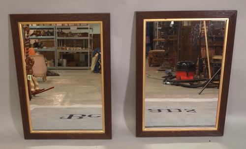 A pair of early 20th century parcel gilt oak rectangular wall mirrors, 84cm wide x 60cm high, (2).