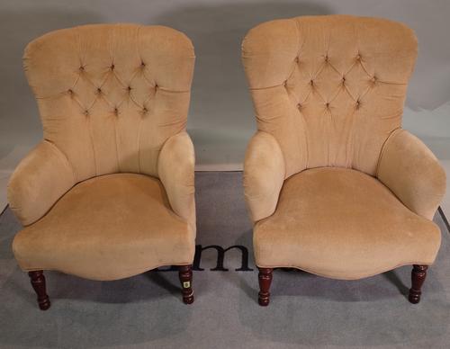 A pair of 20th century hardwood framed low armchairs with green button back upholstery, 64cm wide x 85cm high, (2).