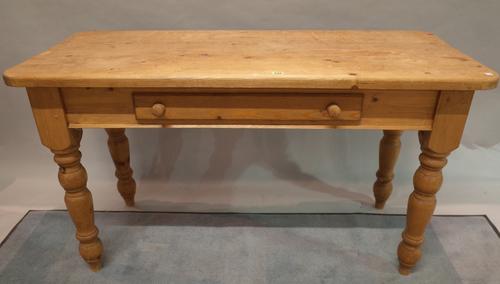 An early 20th century pine single drawer side table on turned supports, 135cm wide x 76cm high.