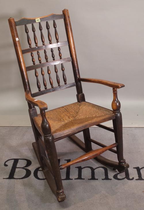 An ash and elm spindle back rocking open armchair, 59cm wide x 105cm high.