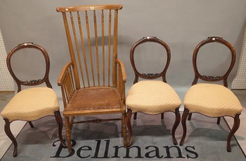 A 20th century stained beech open armchair, 53cm wide x 111cm high, and a group of three Victorian mahogany balloon back dining chairs, 45cm wide x 86