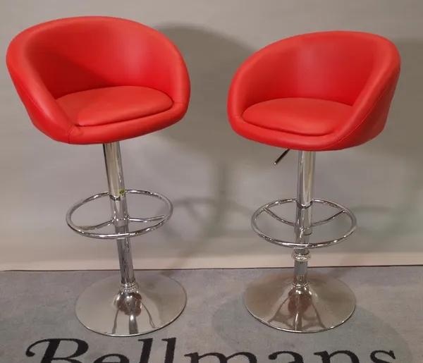 A pair of 20th century chrome and red leather height adjustable bar stools, 55cm wide x 103cm high.