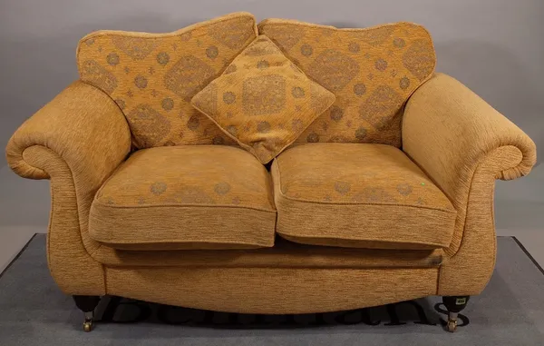A 20th century two seater sofa with roll over arms on turned supports, 155cm wide x 95cm high.