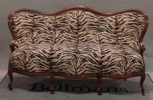 A late 19th century Continental arch back mahogany sofa on cabriole supports, 180cm wide x 100cm high.