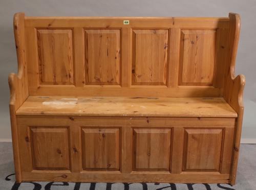 A 20th century pine settle with cupboard base, 120cm wide x 90cm high.
