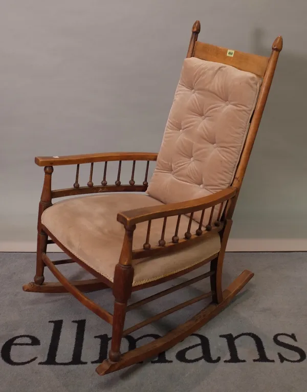An early 20th century stained beech ladderback rocking armchair, 56cm wide x 107cm high.