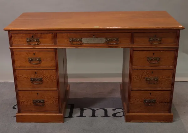 A Victorian pitch pine pedestal desk with nine drawers about the knee, 122cm wide x 59cm deep.