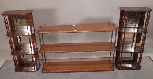 A pair of faux rosewood mirror back hanging four tier shelves, 32cm wide x 75cm high, together with another three tier shelf, 91cm wide x 55cm high, (