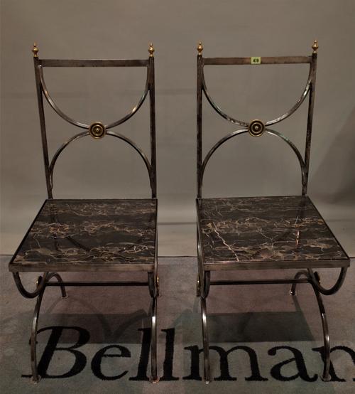 A pair of 20th century steel hall chairs with inset marble seats, 47cm wide x 105cm high, (2).
