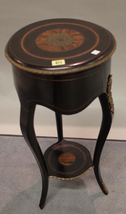 A late Victorian ebonised and ormolu mounted circular lift top side table on cabriole supports, 32cm diameter x 72cm high.
