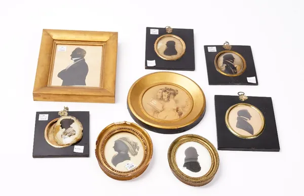 A group of 19th century portrait miniature silhouettes and a drawing of two young ladies, within ebonised and gilt frames (8).