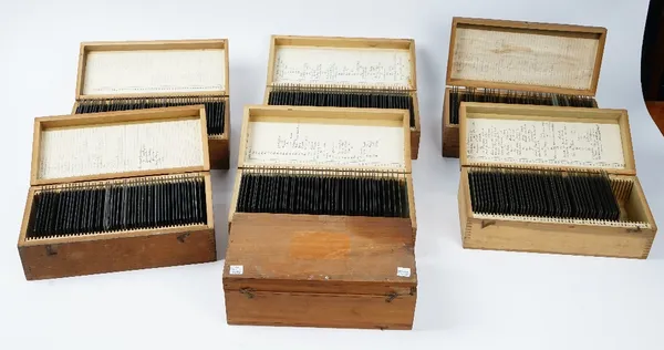 A large collection of four inch glass magic lantern slides, to include portraits and views of Switzerland, contained in seven boxes (qty)