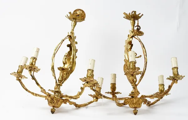 A pair of 20th century gilt metal five branch chandeliers and ceiling roses, in the rococo style, fitted for electricity, 57cm high.