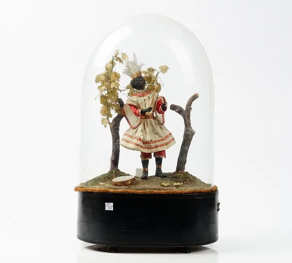 A 19th century automaton of a black musician in a naturalistic landscape, displayed under a glass dome on an ebonised base, height approx, 54cm (a.f).