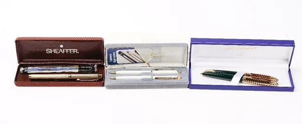 S.T. Dupont, a gilt metal fountain pen and ballpoint pen set, a Waterman green and gilt metal rollerball and ballpoint pen set, a Sheaffer fountain pe