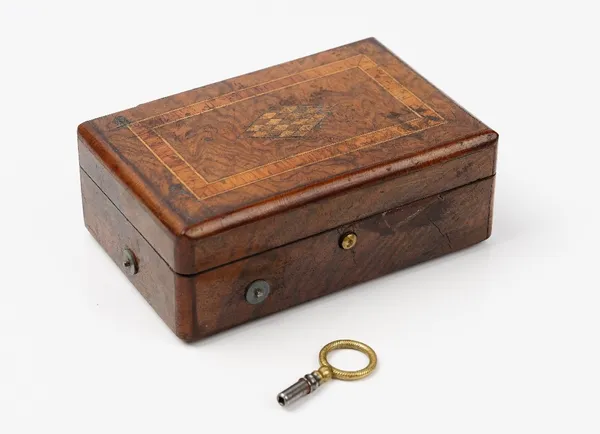 A Swiss walnut and inlaid music box, late 19th century, playing two airs, on a three inch brass roller, 12.5cm wide, (key). (a.f).