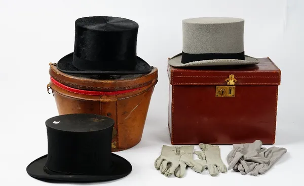 John Hutton & Sons, Newcastle upon Tyne, a gentleman's black silk top hat, in a fitted leather lockable carry case, a grey top hat in a leather case a