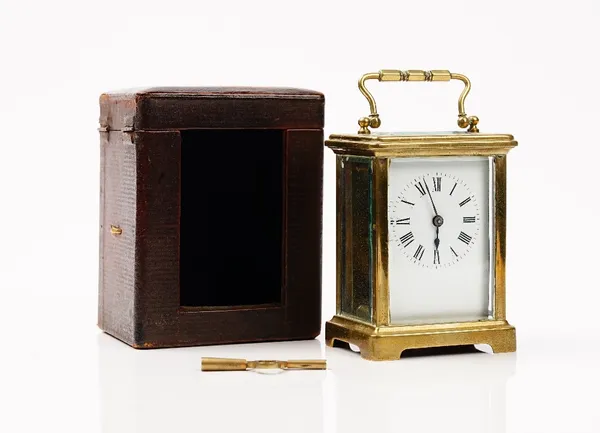 An late 19th century French brass cased carriage clock, with leather travelling case and winder, height 14cm.