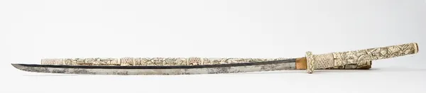 A Japanese carved bone long sword Meiji period, the hilt and scabbard carved in relief with figures, 121cm long.