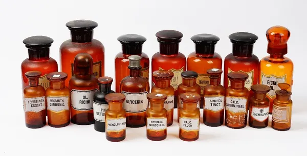 A collection of twenty one 20th century brown and amber glass apothecary jars, the largest 26cm high (21).