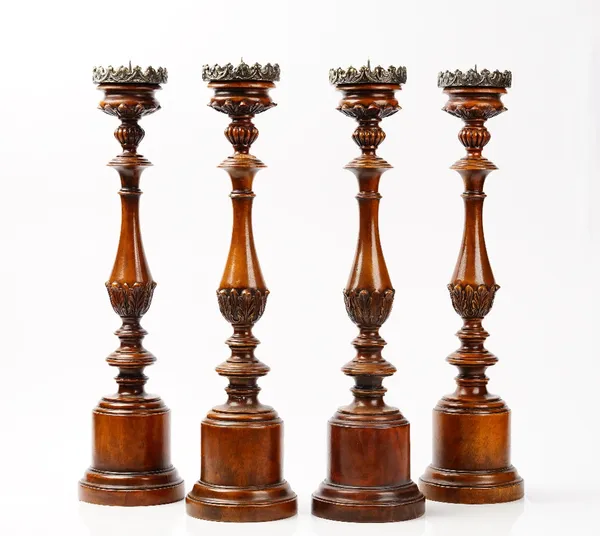 A set of four 20th century carved oak altar sticks, 58cm high. (4)