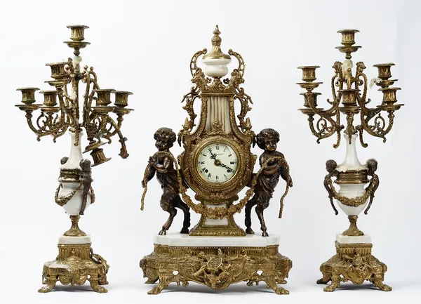 An Louis XVI style gilt metal mounted clock garniture, 20th century, the clock having a white painted dial detailed IMPERIAL MADE IN ITALY and the mov