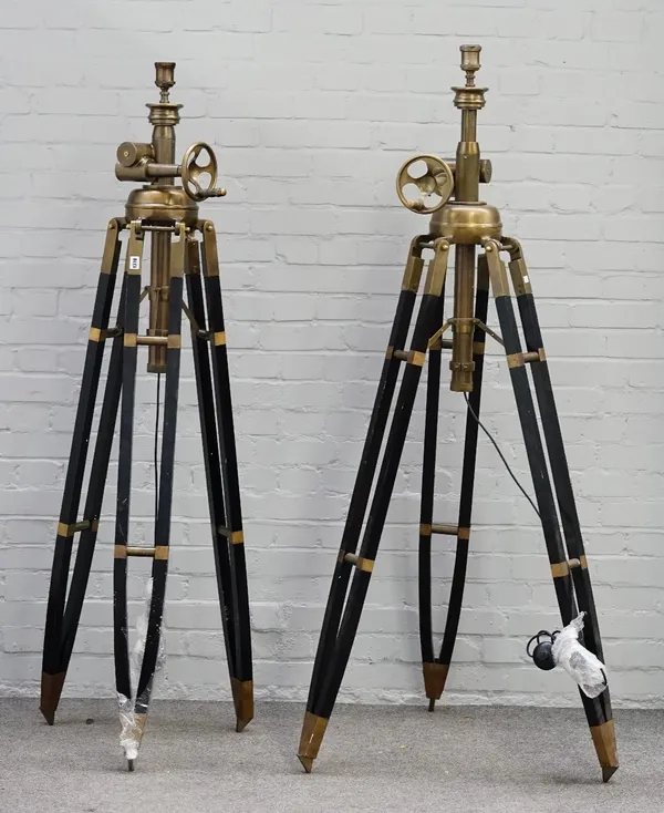 A pair of modern black painted wood and brass height adjustable tripod standard lamps, 193cm high fully extended.