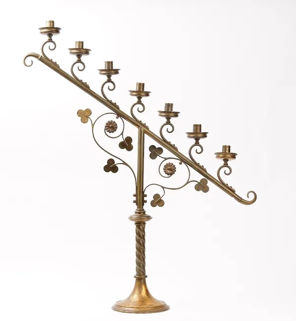 A pair of early 20th century brass seven branch candelabra, with scroll-work decoration, raised on circular pedestal feet, 82cm high x 70cm wide.