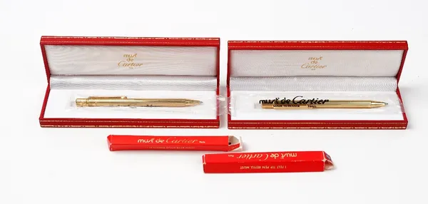 Must De Cartier, Paris, two ballpoint pens, each in plastic sleeves, with boxes and two refills.