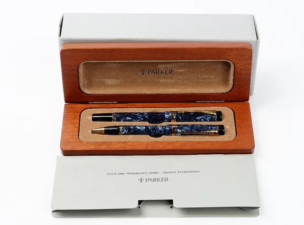 The Parker Duofold International, a blue marble fountain pen, with 18k nib, together with a matching ballpoint pen, with mahogany case and booklet, tw