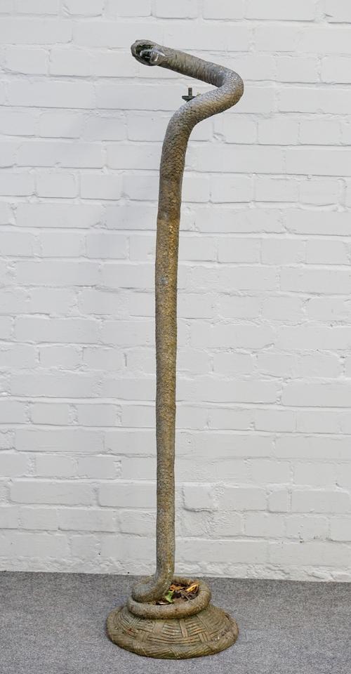 An early 20th century tall bronze standard lamp formed as a coiled snake resting on a basket moulded base, 148cm high.
