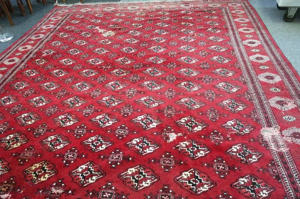 A Bokhara carpet with all over design and sunburst border, 395cm x 300cm. 6918