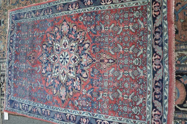 A Mahal rug, Persian, the madder field with a bold medallion, herate supporting pattern; an indigo leaf and flower border, 158cm x 111cm.